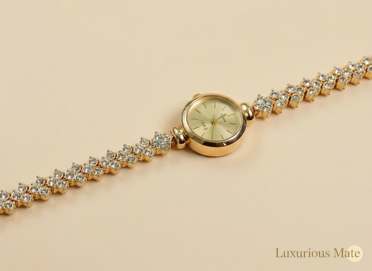 Gold watch with diamond-studded bracelet on a beige background