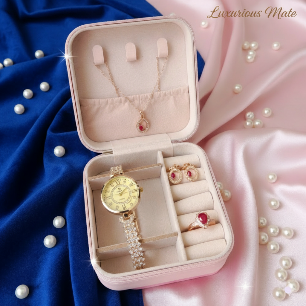 Pink jewelry box with gold watch, earrings, and rings on a pink and blue fabric background.