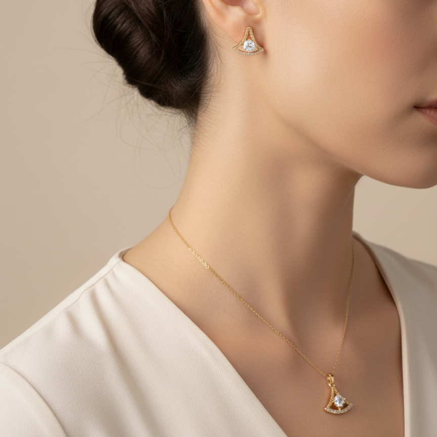 Woman wearing gold earrings and necklace against a beige background