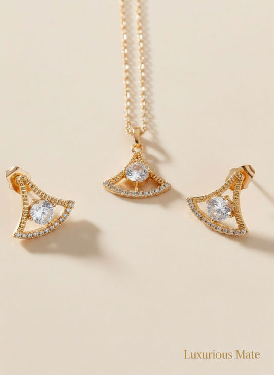 Gold necklace with triangular pendant on a beige background