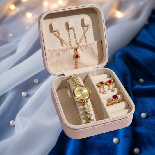 Jewelry set including a watch, necklace, and earrings in an open jewelry box on a soft fabric background.
